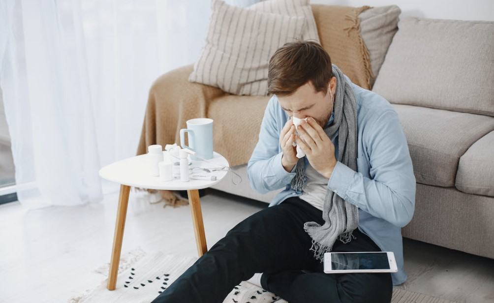 man sneezing in room